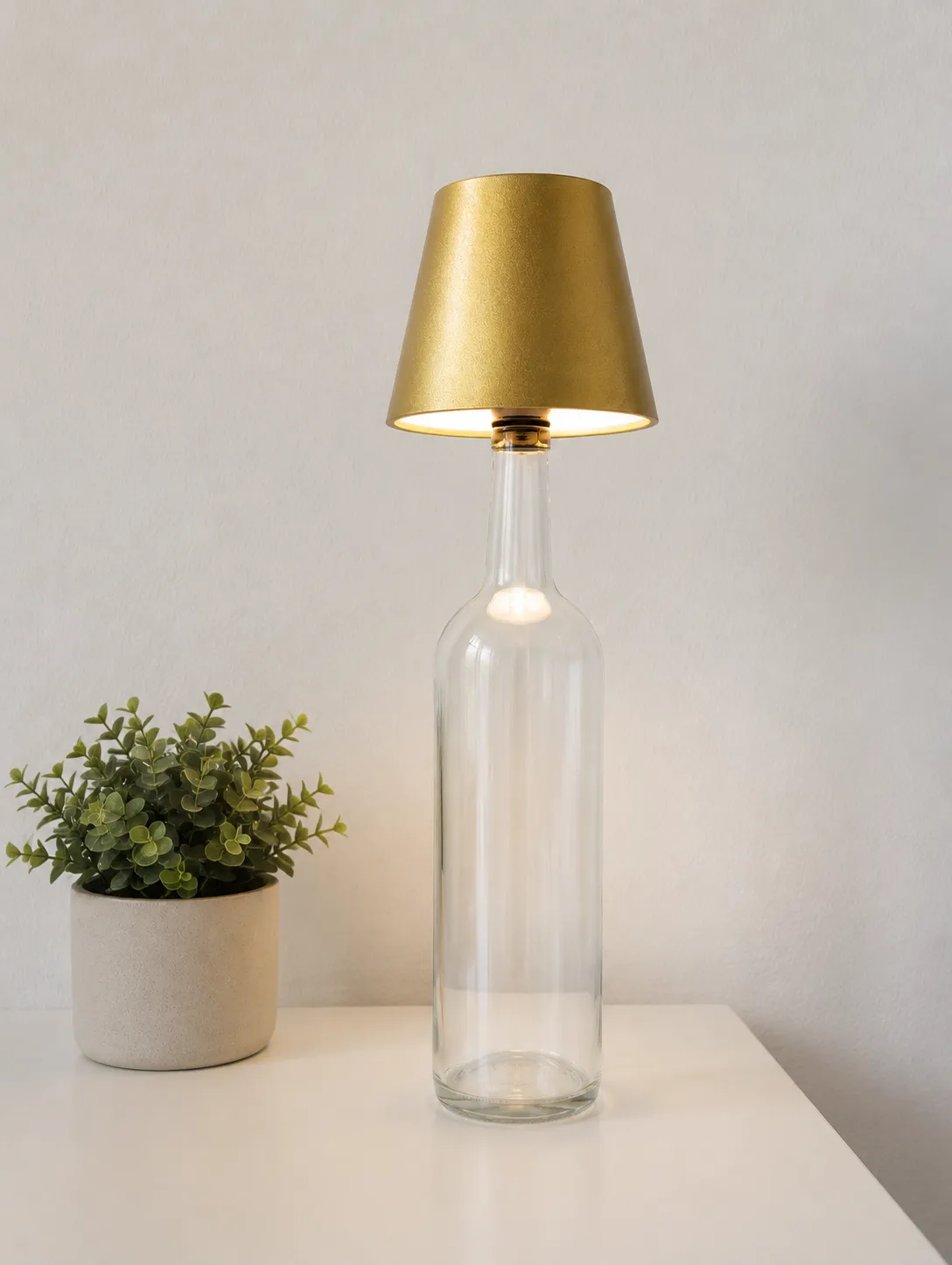 GlowVine bottle lamp on a styled shelf casting warm ambient light